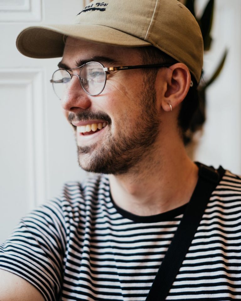 positive young male smiling and looking away