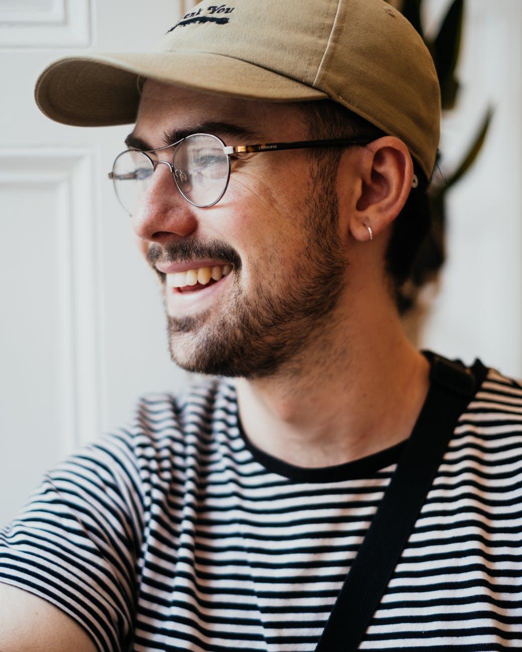 positive young male smiling and looking away